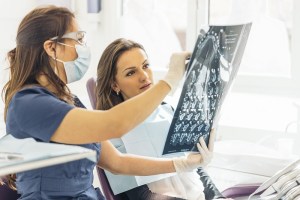 Dentist showing x-ray to patient
